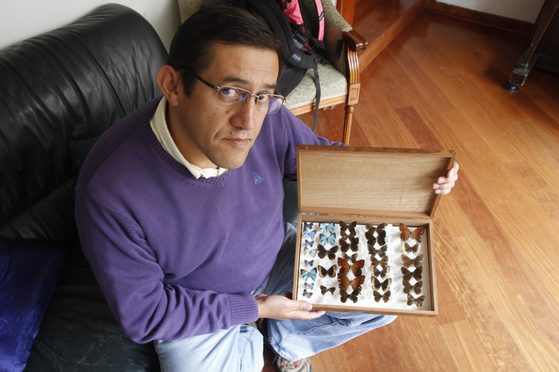 Gonzalo Andrade poses with part of his personal butterfly collection in Bogota